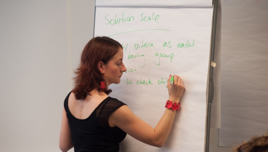 Student writing on a flip chart